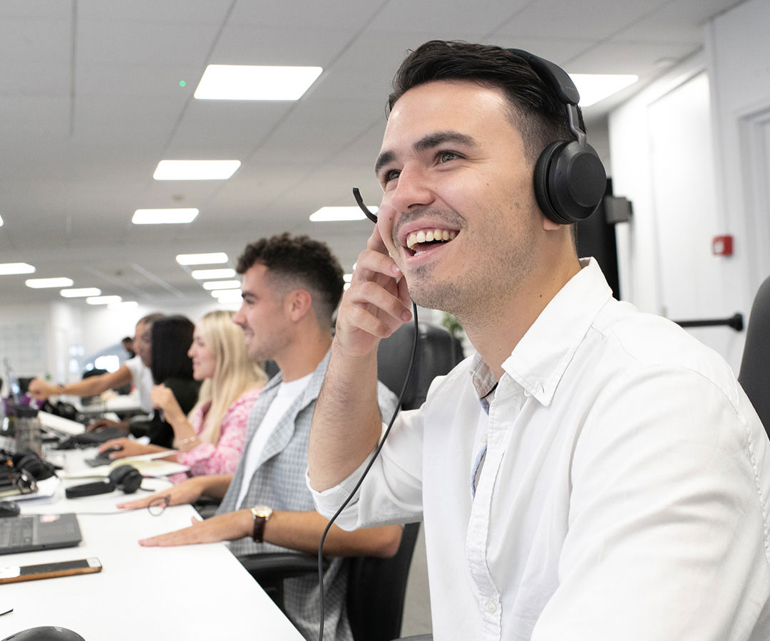 Man smiling while on the phone on his headset
